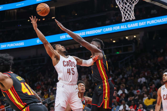 Feb 24, 2023; Atlanta, Georgia, USA; Cleveland Cavaliers guard Donovan Mitchell (45) shoots over Atlanta Hawks center Clint Capela (15) in the first quarter at State Farm Arena. Mandatory Credit: Brett Davis-USA TODAY Sports